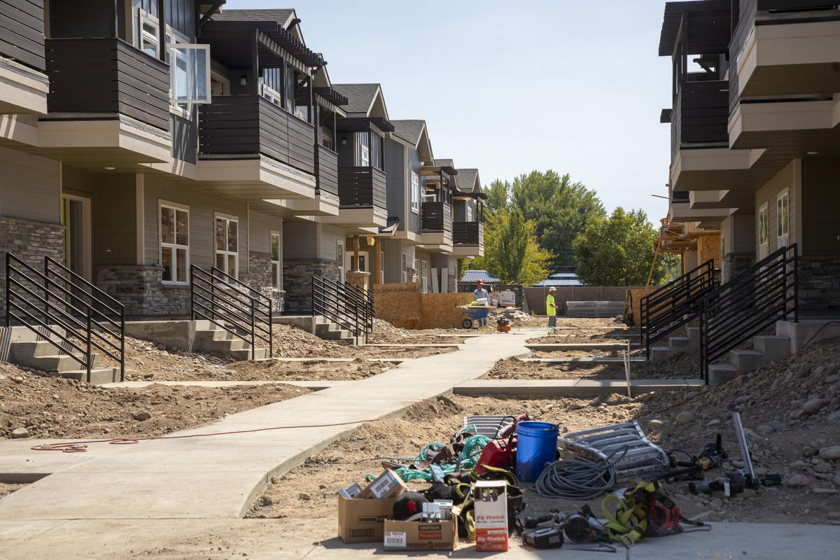 Construction workers build out a row of townhouses, part of Parkway Station. 