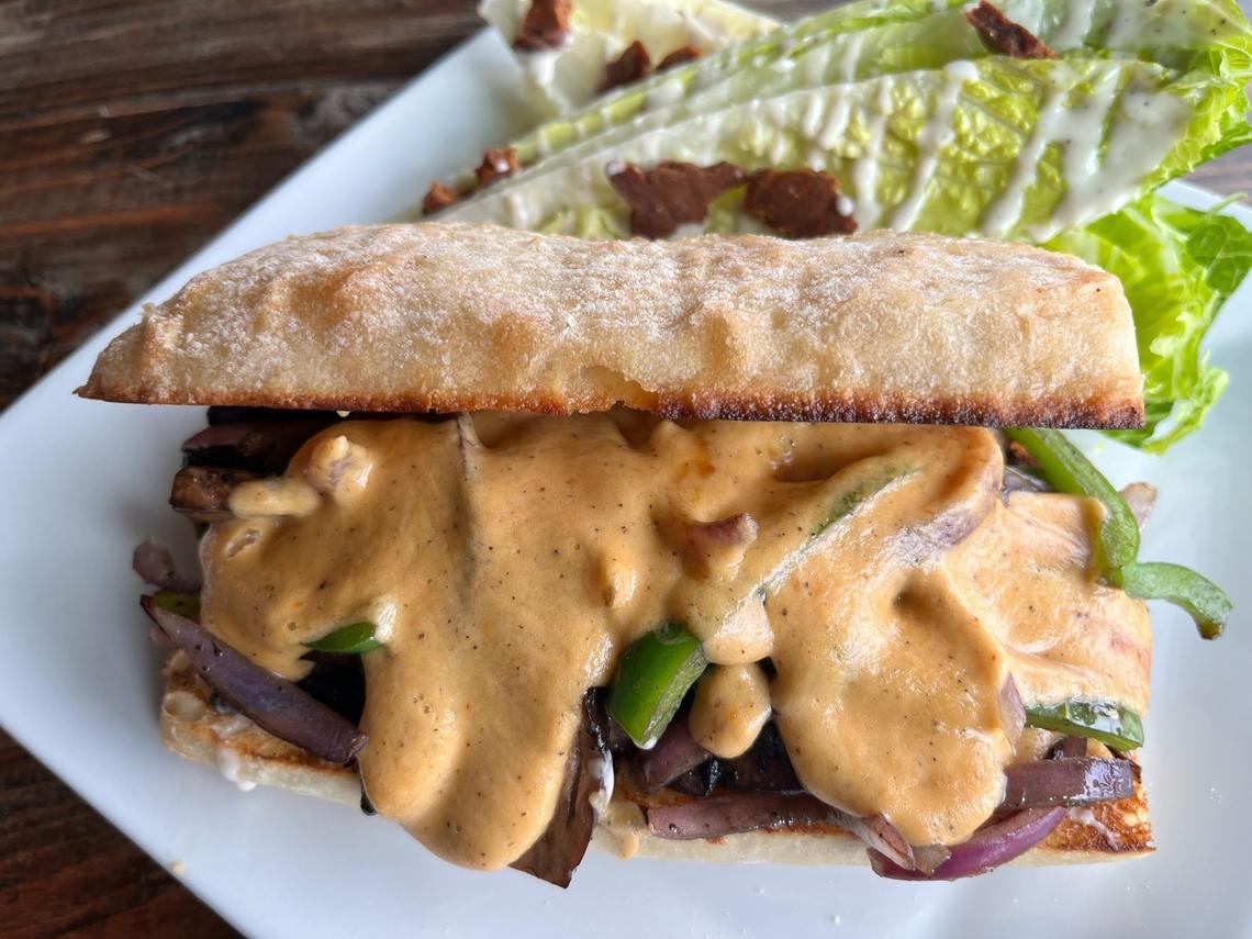 The proudly messy Philly Cheez-Shroom ($17) is portabello mushrooms, onions, bell peppers, vegan queso and “mushroom jus” on a hoagie.