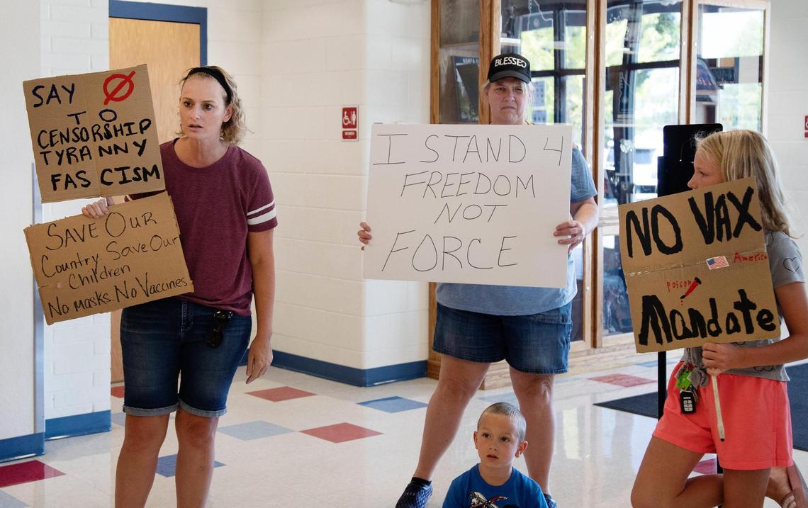 A few protesters stand outside of the Nampa High School gymnasium as Gov. Brad Little gives a speech urging Idahoans to get the COVID-19 vaccine ahead of the fall school year.