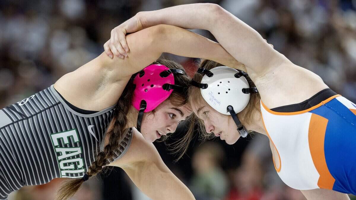Eagle's Caddy Tverdy, left, and Tri-Valley's Charlee Noah, right, compete in the 125-lbs. division first place match at the Idaho state wrestling championships held at the Ford Idaho Center in Nampa, Saturday, Feb. 28, 2026. Noah won 4-0 in a decision.
