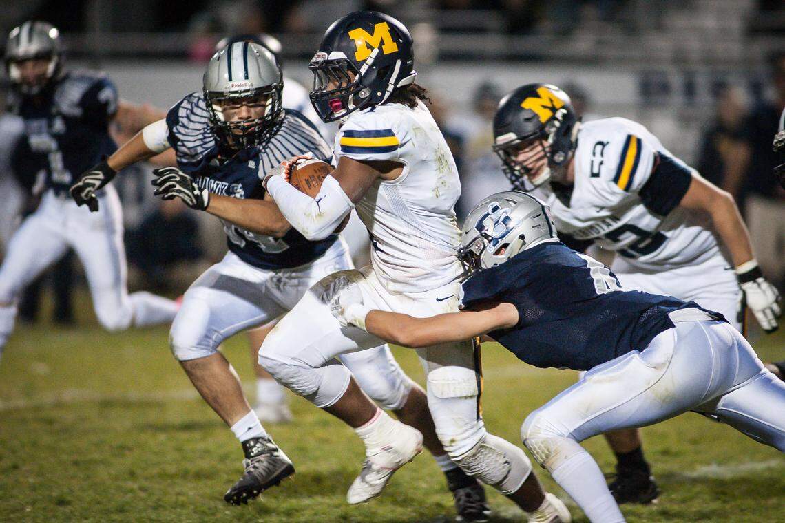 Meridian’s Javen Woodall breaks through the Skyview defense Friday in Nampa. Despite the loss, the Warriors (3-6) are headed to the playoffs and face Madison (6-3) on the road in the first round.