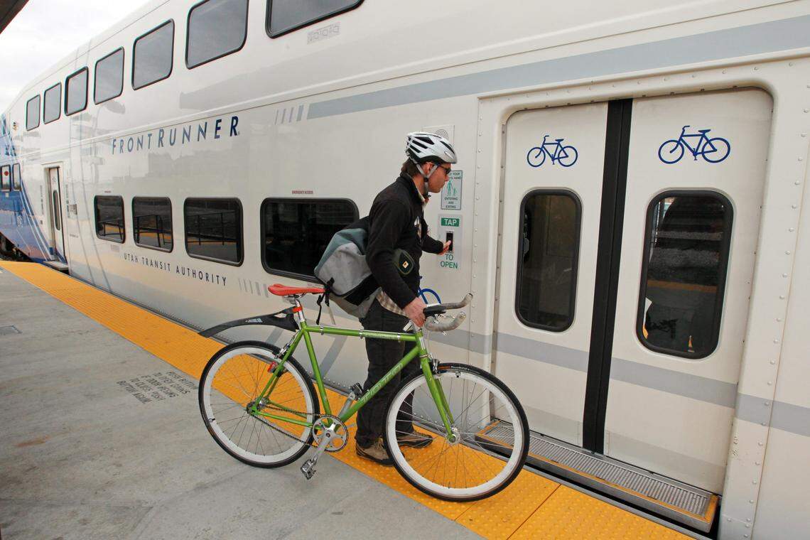 A commuter taps a button to board the Utah Transit Authority’s “Frontrunner’” train after it arrives at a Salt Lake City station from Ogden.