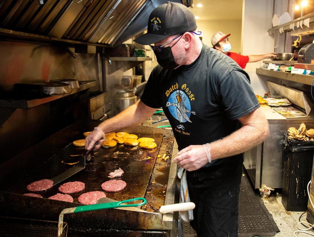 Dutch Goose owner Tom Moroney cooks burgers for customers on the next-to-last day of one of Boise’s iconic pub and grills. The State Street restaurant offers $10 2-for-1 bacon-cheeseburger combos.