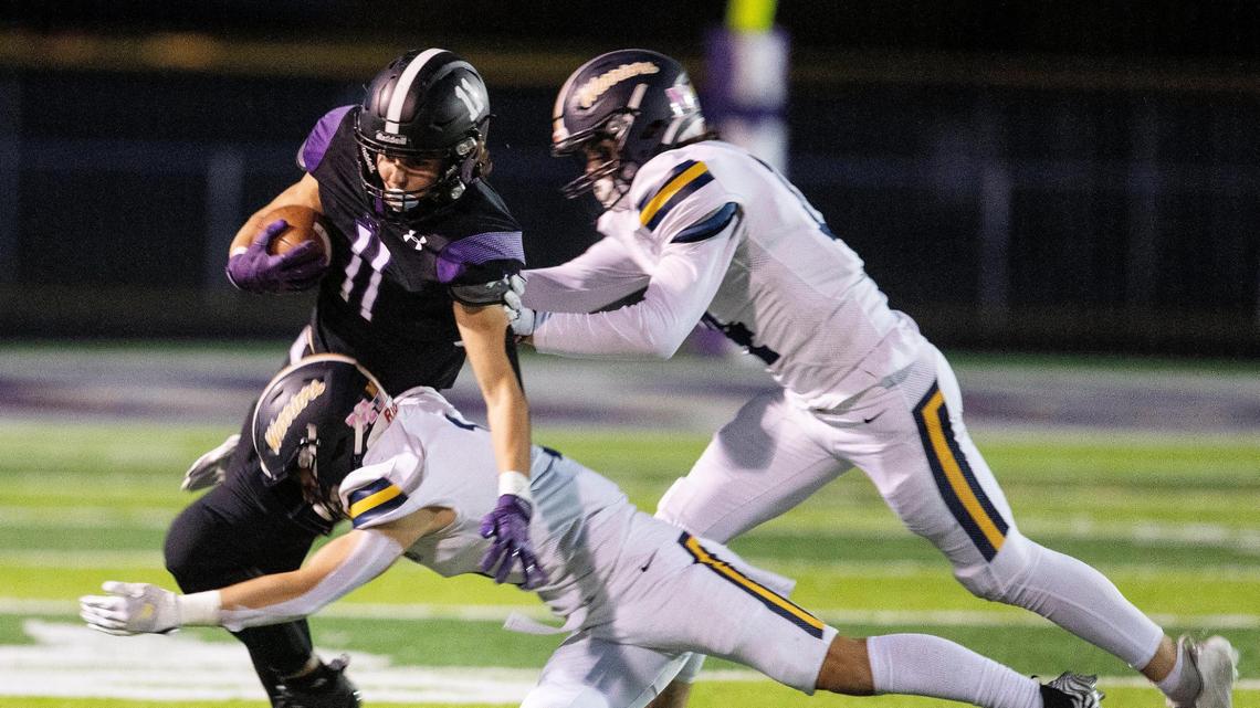Rocky Mountain’s Luke Luchini tries to evade Meridian tacklers after a catch Friday.