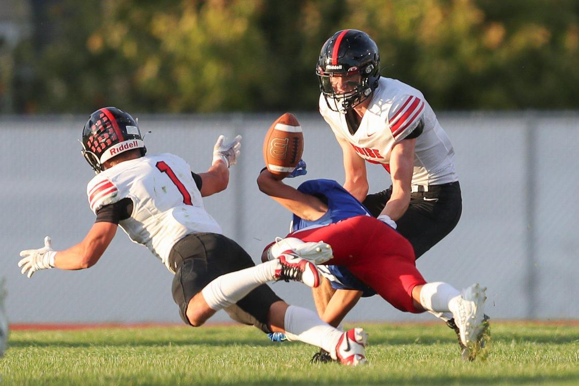 Boise defensive back Max Anderson, left, forces the ball loose from Nampa receiver Kartez Hernandez and into the hands of linebacker Duncan Thompson for an intecption Sept. 8. The No. 5-ranked Brave (4-0) host No. 3 Mountain View (3-1) in their first big test of the season Thursday night.