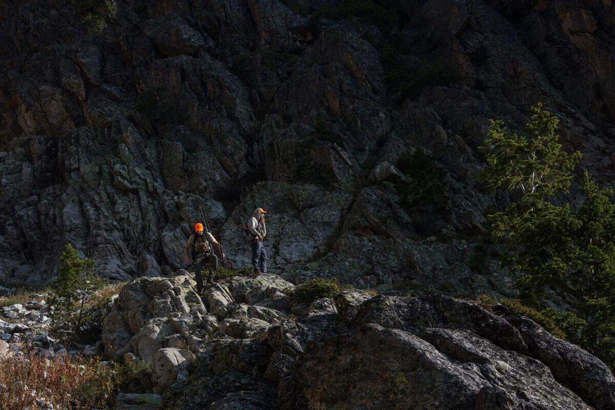 Pete Mumford and Taylor Glenn return from a fifth-class climbing excursion last month while in pursuit of a mountain goat high in Cascade Canyon. Glenn, an experienced climber, likened the challenging effort to “mountaineering with a rifle.”