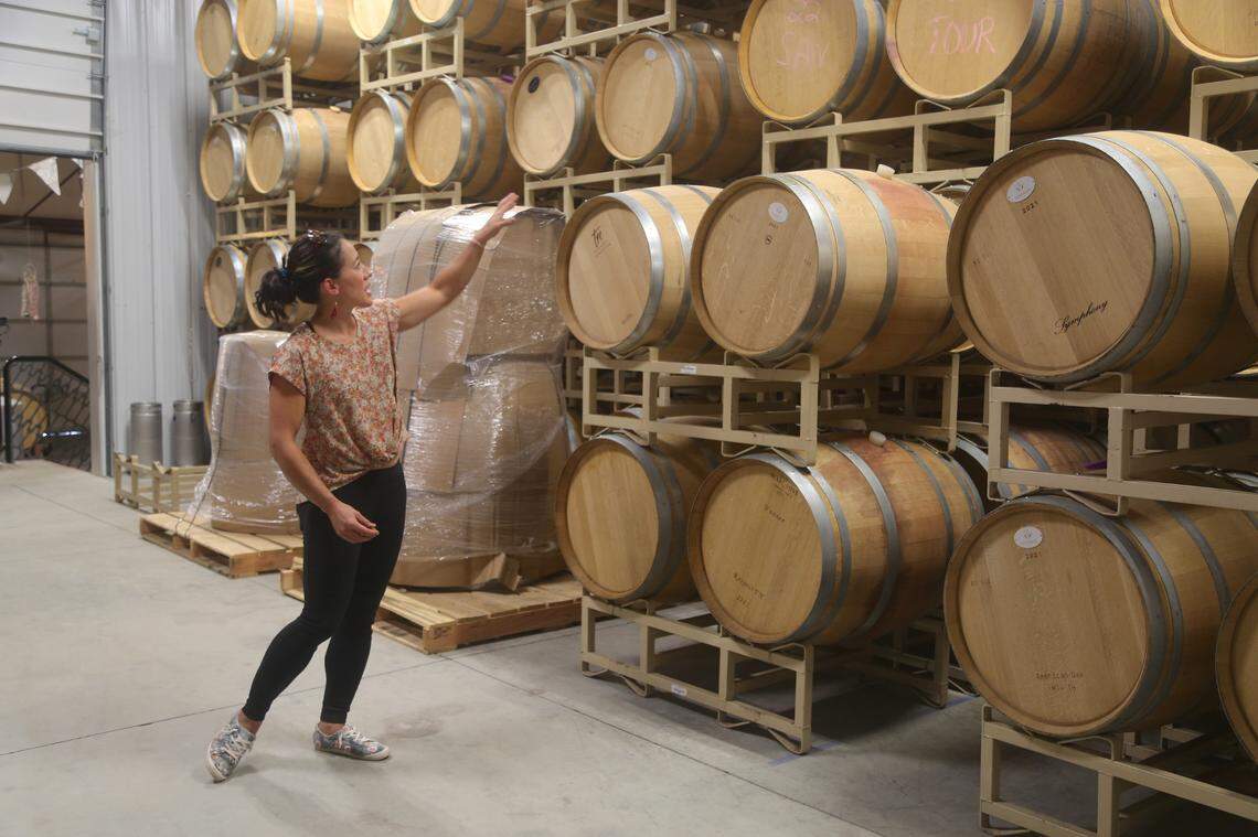 Tammy Stowe-McClure points to barrels of wine at Indian Creek Winery in Kuna. The winery is family owned and operated. It was founded by Stowe-McClure’s parents in 1982.
