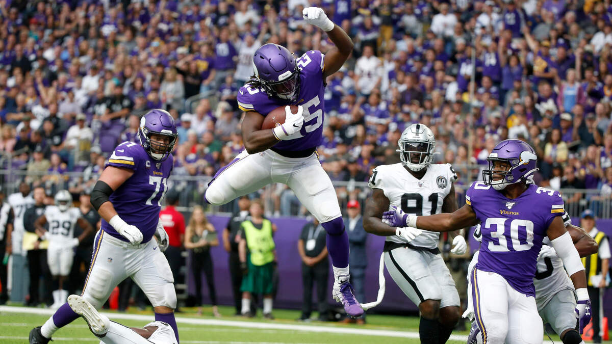 Minnesota Vikings running back Alexander Mattison, who played at Boise State, scores on a 10-yard run by hurdling an Oakland Raiders defender Sept. 22, 2019, in Minneapolis. The Vikings won 34-14.