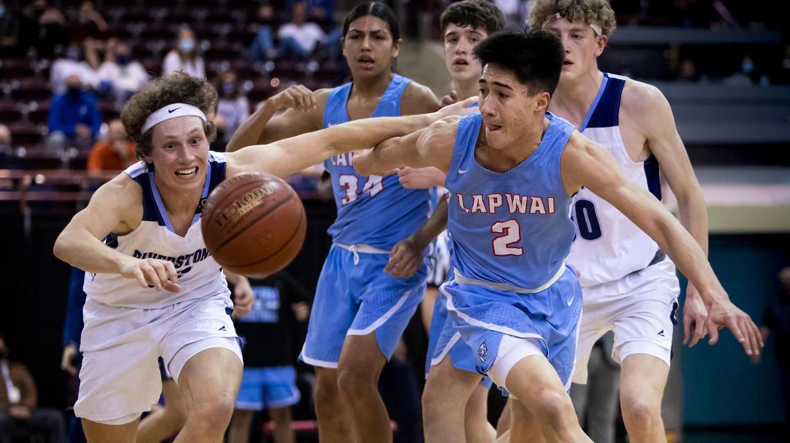 Riverstone senior Jacoby Smith, left, chases a loose ball with Lapwai’s Titus Yearout in the 1A Division I boys basketball state championship Friday at the Ford Idaho Center in Nampa.
