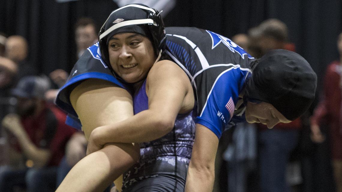 Rocky Mountain’s Lita Burgaracruz lifts Kylie Kemp of Walla Walla off her feet during their 120-pound match Friday at the Rollie Lane Invitational. The 20-year-old tournament is hosting its first all-girls division this year, drawing 85 female wrestlers to the state’s largest tournament.
