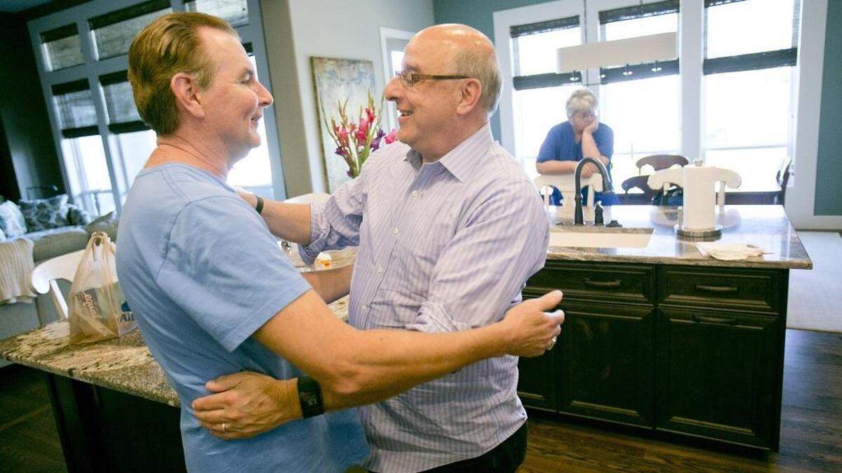 Ray Flachbart, left, greets old friend David Kantor at his house in Eagle, Idaho. 
