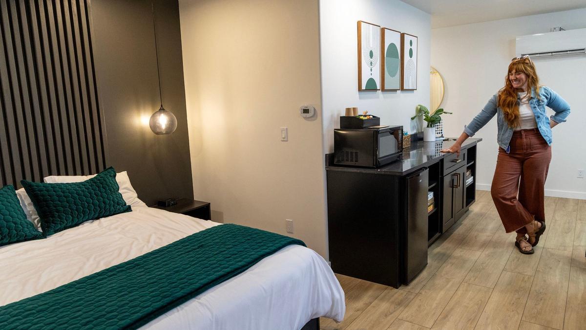 Santiago shows off a finished room as the renovation nears completion.
