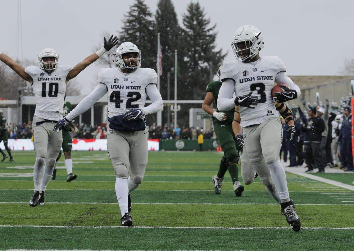 Utah State safety Jontrell Rocquemore (3) runs an interception back for a touchdown against Colorado State during the second half Saturday, Nov. 17, 2018, in Fort Collins, Colo.