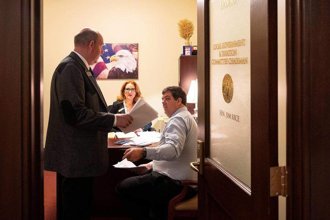 After a closed-door meeting with Sen. Jim Rice, R-Caldwell (right), the chairman of the Senate Local Government & Taxation Committee, Rep. Mike Moyle, R-Star, the House majority leader, revisits some of the conversation about language and numbers in a bill Moyle hoped to introduce in that morning’s legislative session. Moyle and Rice were far from agreement on the bill.