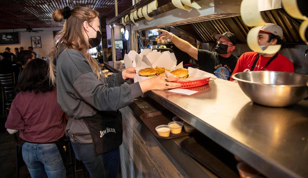 Madi Glover picks up lunch orders from Dutch Goose owner Tom Moroney during a busy lunch hour Tuesday. The popular pub and grill will close after business Wednesday, Dec. 30.