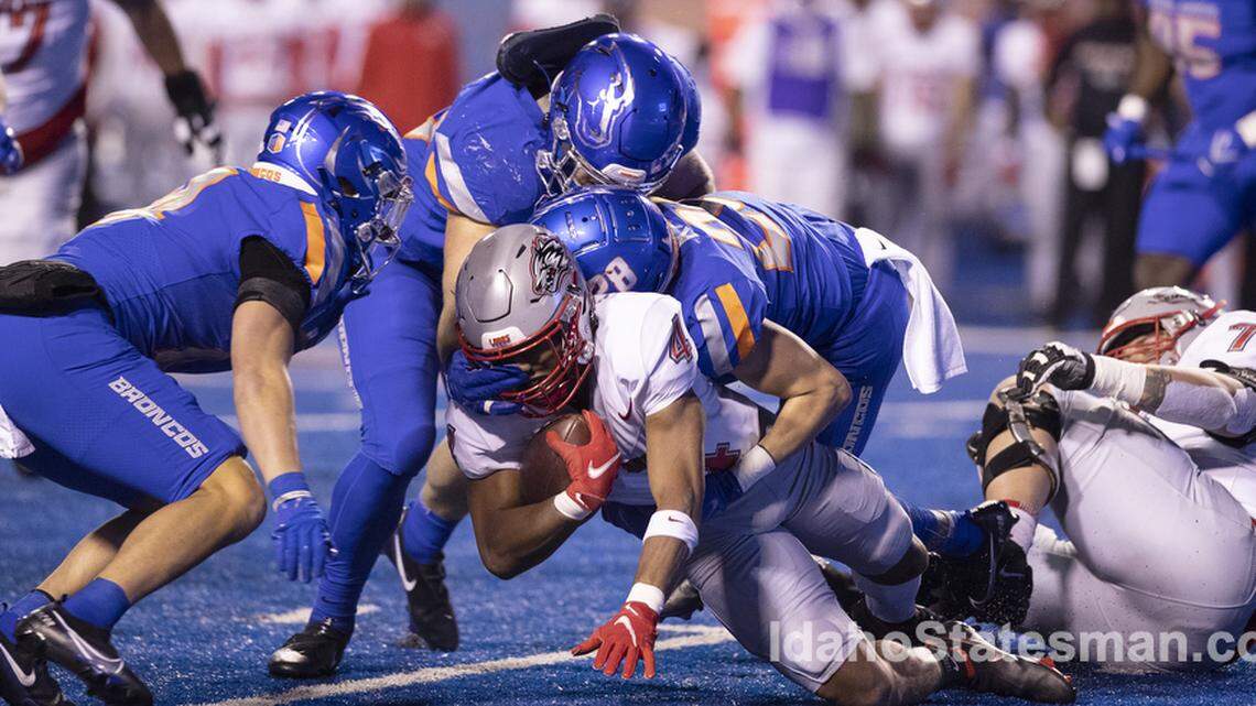 Boise State nickle Kekaula Kaniho takes down New Mexico running back Bobby Wooden in the first half of the Broncos’ 37-0 win on Saturday. Boise State held the Lobos to 84 rushing yards.