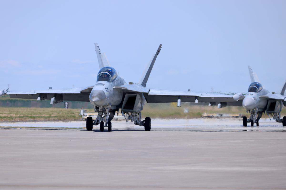 Two Navy Super Hornet/Growlers taxi on the tarmac on Friday. 