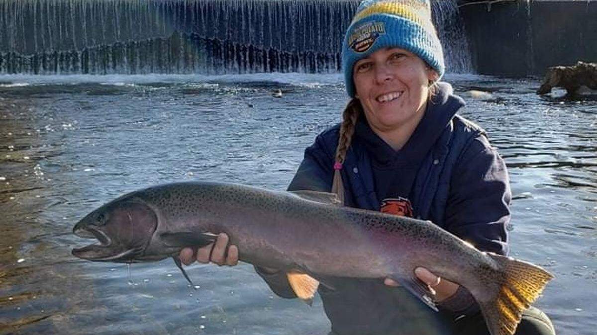 Kaysha Goleman shows off a steelhead she caught on the Boise River.