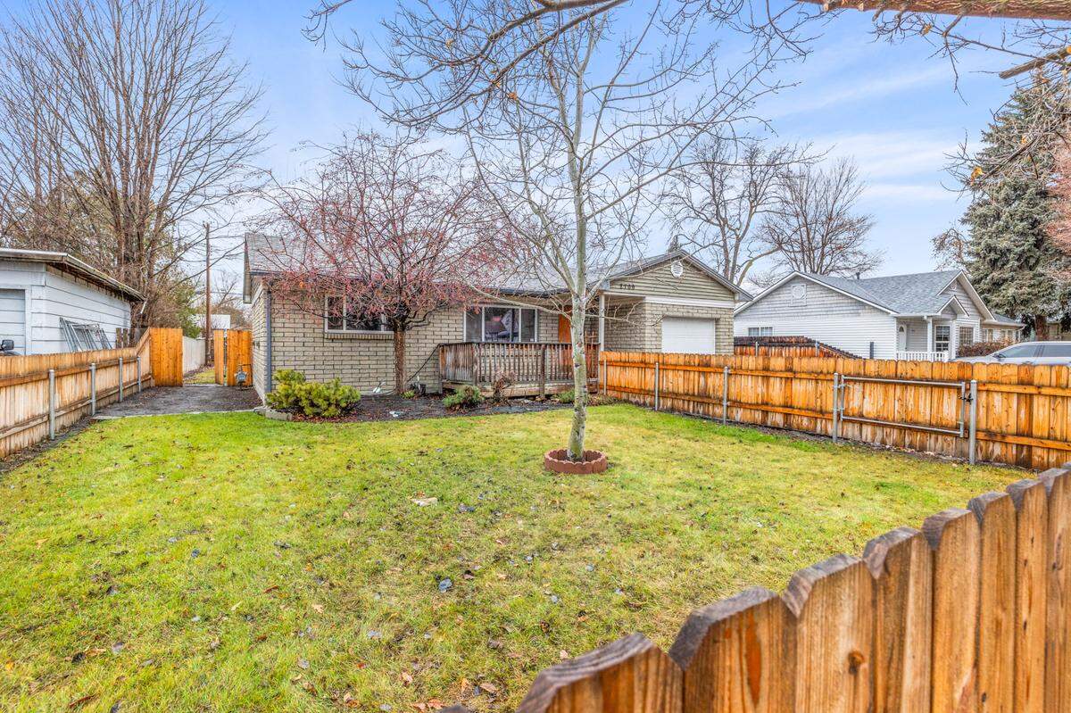 The Woody Drive home includes a single-car garage and both a large front yard and backyard