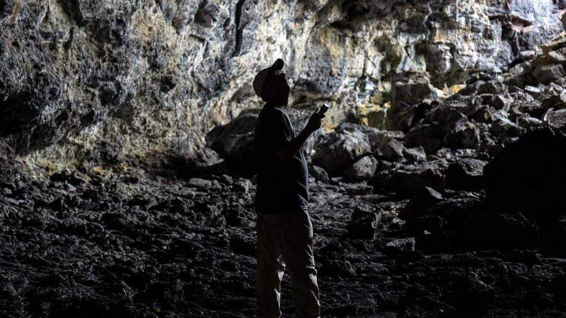 Ray Maynard of Austin, Texas explores a lava tube at Craters of the Moon National Monument and Preserve in this 2022 file photo.