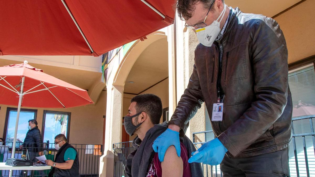 Juan Cardenas, 19, receives the Moderna COVID-19 vaccine from James Hunt, a clinical pharmacist with Terry Reilly Health Services, at the Community Council of Idaho on March 23.