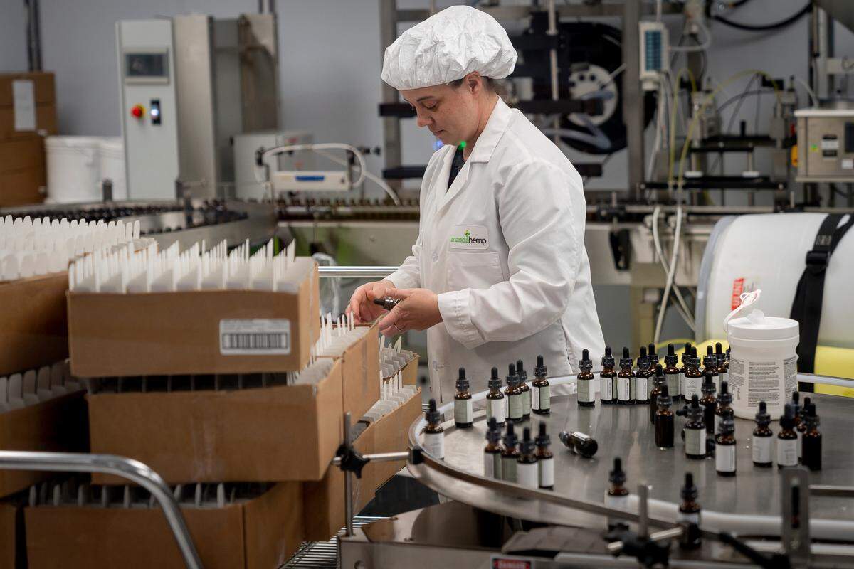 A worker processes and packages vials of hemp oil for shipping at Ananda Hemp in Cynthiana, Ky., Thursday, Jan 24, 2019. (AP Photo/Bryan Woolston)