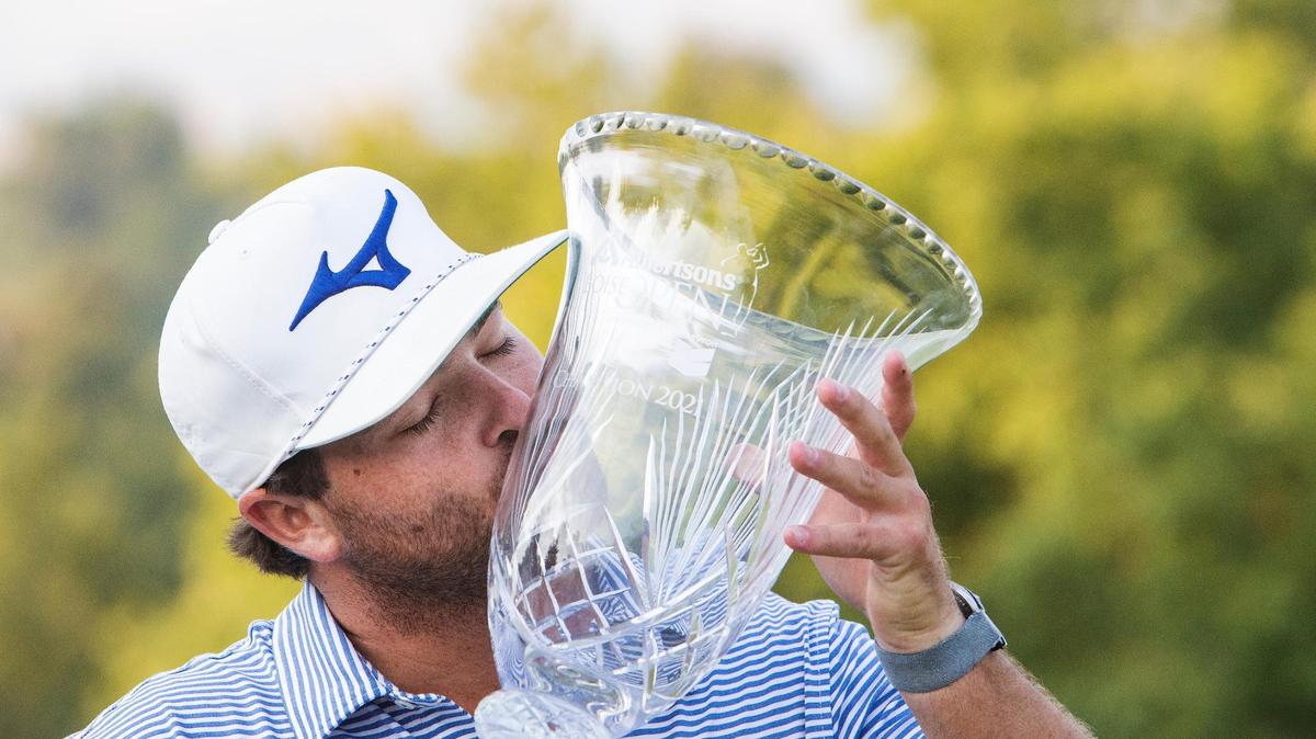 Winner Greyson Sigg kisses his trophy at the Albertsons Boise Open on Sunday at Hillcrest Country Club.