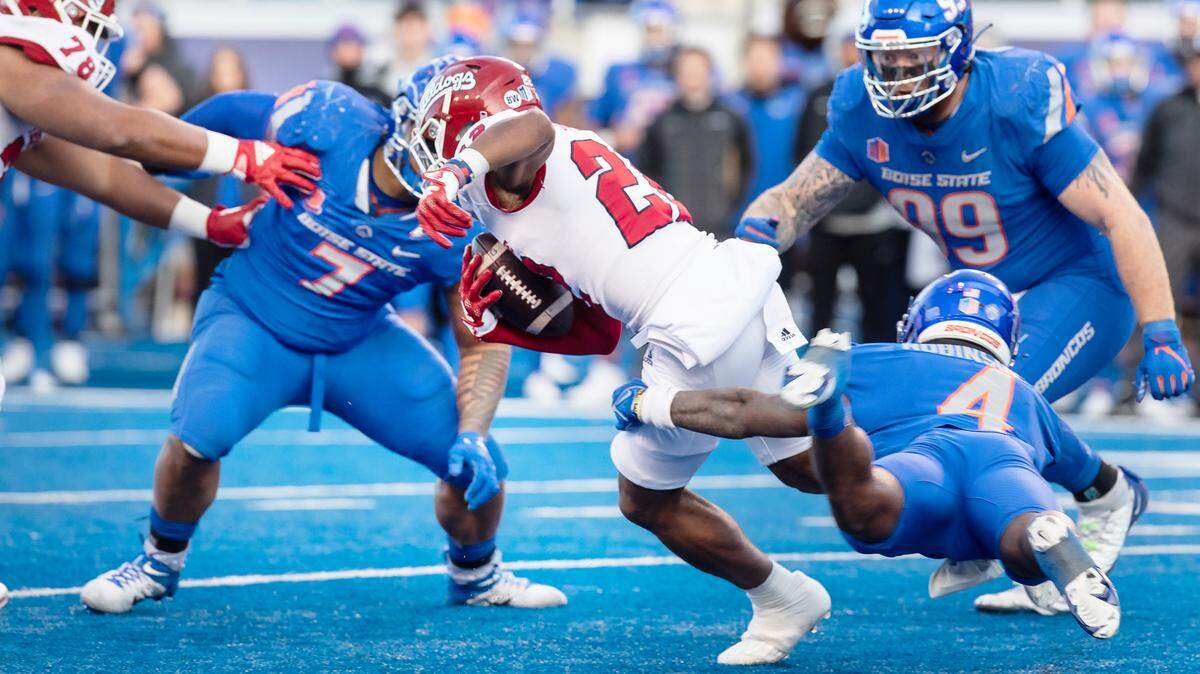 Fresno State running back Malik Sherrod is tripped up by Boise State safety Rodney Robinson in the third quarter of the Mountain West Championship game held on Saturday, Dec. 3, 2022 at Albertsons Stadium.
