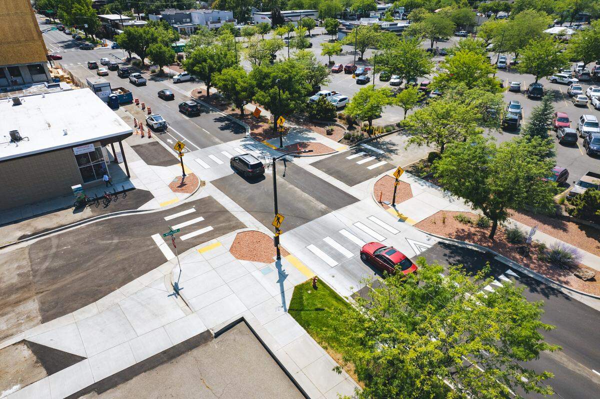 Cars southbound on North 16th Street cross newly installed raised walkways to slow traffic at the intersection with Washington Street, left, and a driveway into the parking lot of the Albertsons supermarket at 1650 W. State St., right..