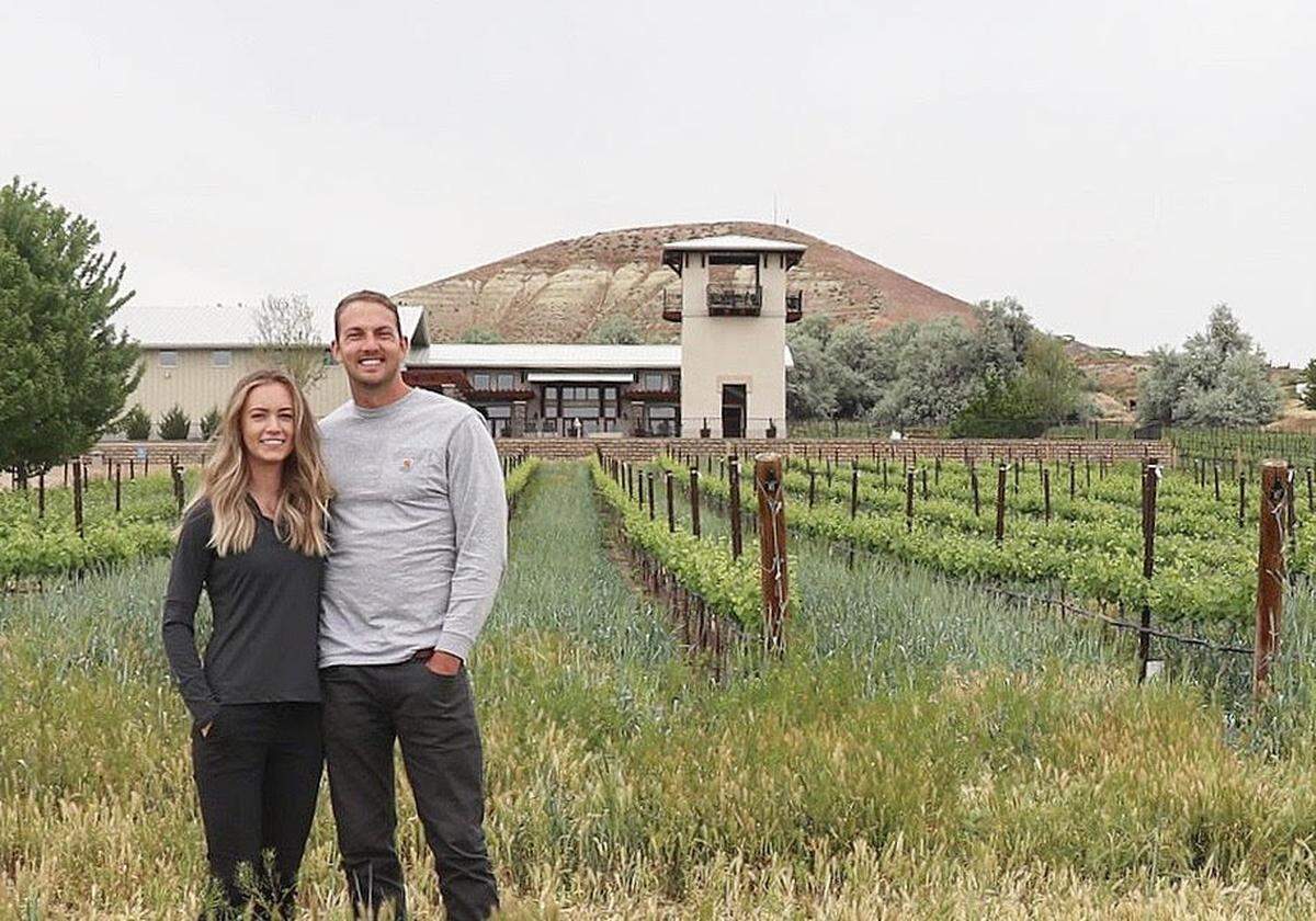 Sydney Weitz-Nederend and James Nederend stand in a vineyard at Koenig Vineyards. The couple, who own Scoria Vineyards, is buying Koenig from Greg and Kristen Koenig.
