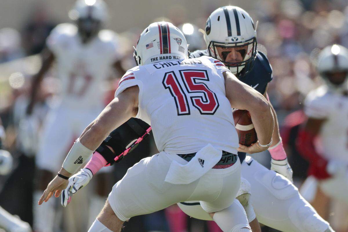 BYU defensive lineman Corbin Kaufusi (90) prepares to hit Northern Illinois quarterback Marcus Childers (15) during the first half of an NCAA college football game at LaVell Edwards Stadium on Saturday, Oct. 27, 2018, in Provo, Utah. (Evan Cobb/The Daily Herald via AP)