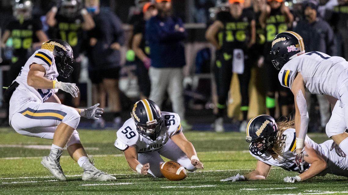 Meridian linebacker Carson Gooley pounces on a Mountain View fumble Friday during the 5A state quarterfinals.