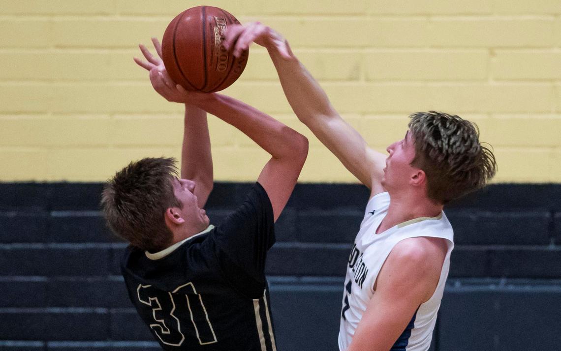 Middleton senior Tyler Robinett blocks a shot by Kuna’s Gavin Gordon during the 4A District Three championship Thursday at Kuna High.