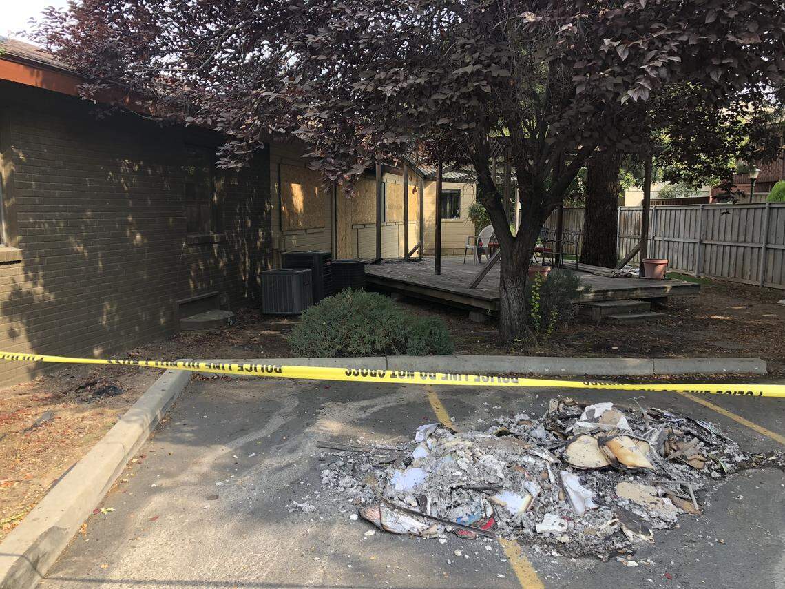 A pile of charred debris sits next to the back of a business mall on Cole Road. Fire burned an unoccupied section of the building Sunday night.