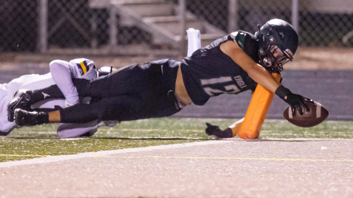Eagle wide receiver Cannon Morgan stretches the ball over the goal line defended by Meridian’s Cruz Crofts in the second quarter Friday, Oct. 2, 2020, at Thunder Stadium in Eagle.