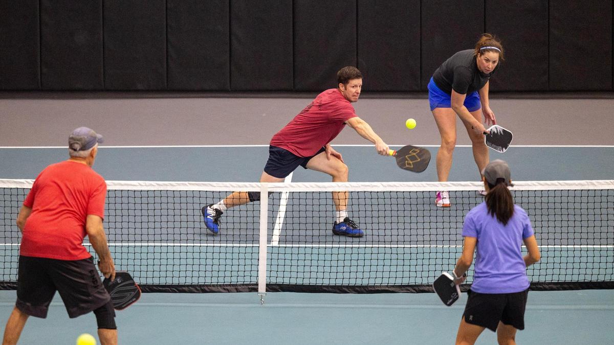 Ryan Myhre of Boise makes contact with the ball during a game at The Flying Pickle, an indoor pickleball complex in Meridian. The Flying Pickle will be hosting a professional and amateur tournament this spring.