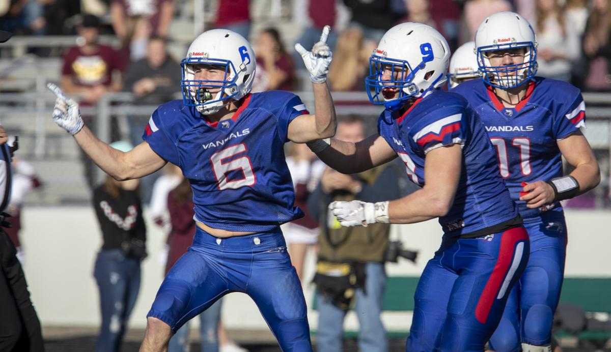 McCall-Donnelly’s Gideon Lowe, left, celebrates an interception in last year’s 2A state title game. The senior and first-team, 2A All-Idaho defensive back leads the Vandals defense as they moved up to the 3A classification.