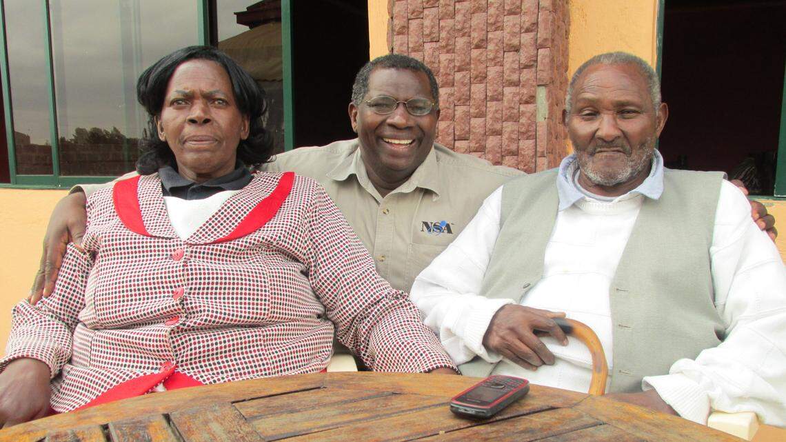 Vincent Kituku, center, with his mother and father.