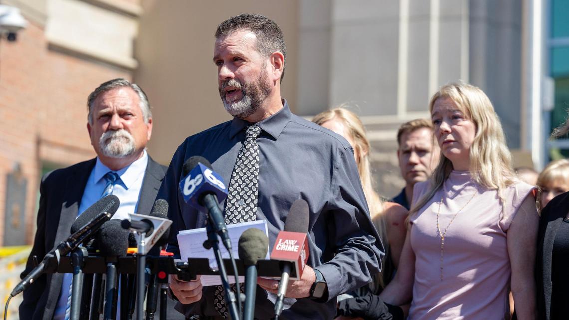 Scott Laramie, center, stepfather of victim Madison Mogen, with his wife Karen Laramie, right, reads a statement to the members of the press outside of the Ada County Courthouse after the sentencing of Bryan Kohberger in July. Their attorney, Leander James, left, joined them at the podium.