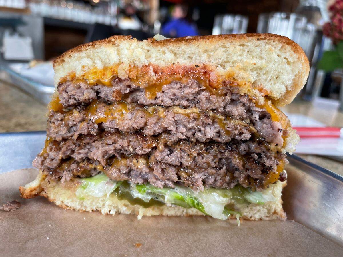 Open wide! Cut in half, the Double Trouble reveals four ground brisket patties.