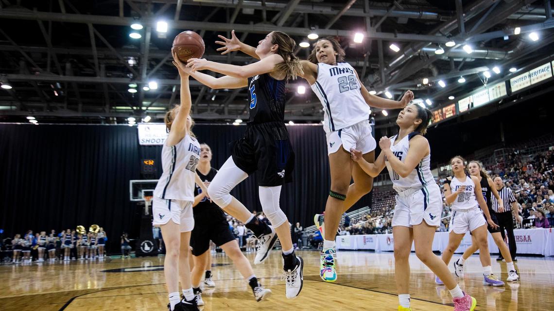 Timberline senior Ava Ranson scores on reverse layup defended by Mountain View’s Naya Ojukwu late in the fourth quarter of the 5A girls state basketball championship Saturday, Feb. 22, 2020 at Ford Idaho Center in Nampa.