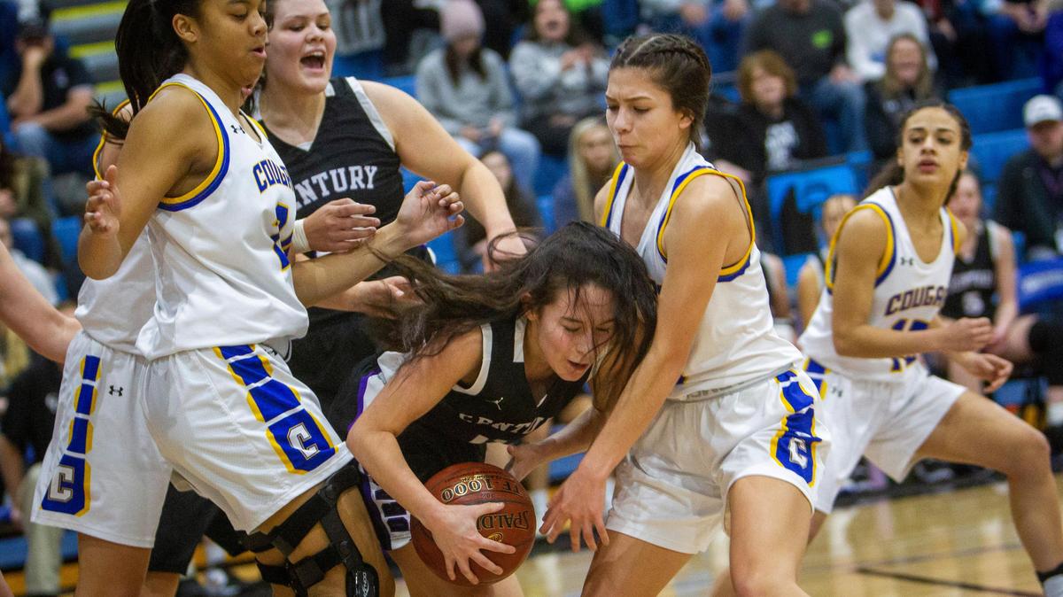 Caldwell’s Aaliyah Kennedy, left, and Jade Martinez defend as Century’s Kassidy Gardea grabs a rebound under Caldwell’s basket.