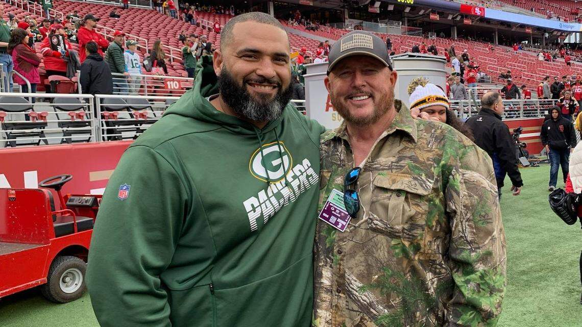 McCall-Donnelly football coach Lee Leslie, right, announced his retirement Wednesday. Above, he poses with Green Bay defensive line coach Jerry Montgomery, a former player of Leslie’s at Hillcrest High in Utah.