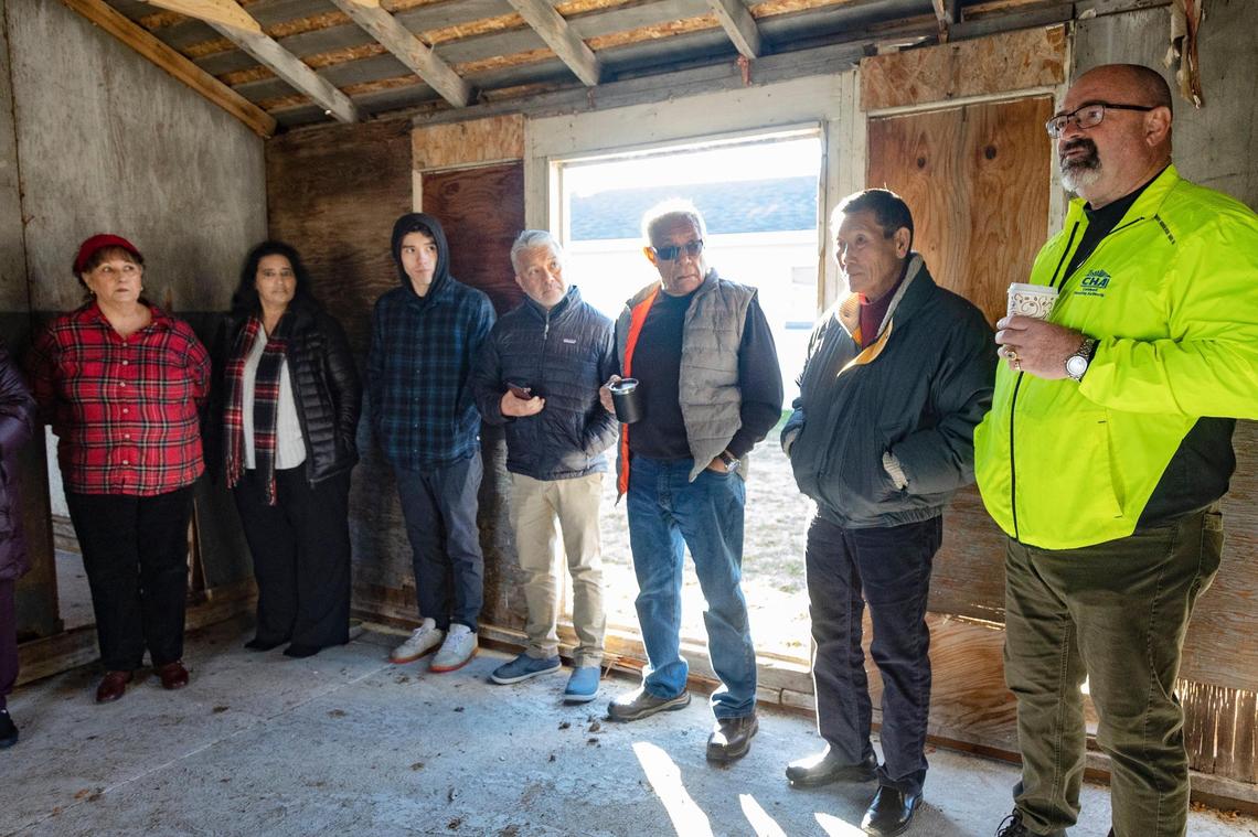 Former residents of Farmway Village and their families visit an original barrack that was recently recovered moved back to the residential site for farmworkers. The village was known by the residents as El Campo de Caldwell. Mike Dittenber, at far right, is the executive director of Caldwell Housing Authority, which is located on site and which is refurbishing the old structure for historical purposes.