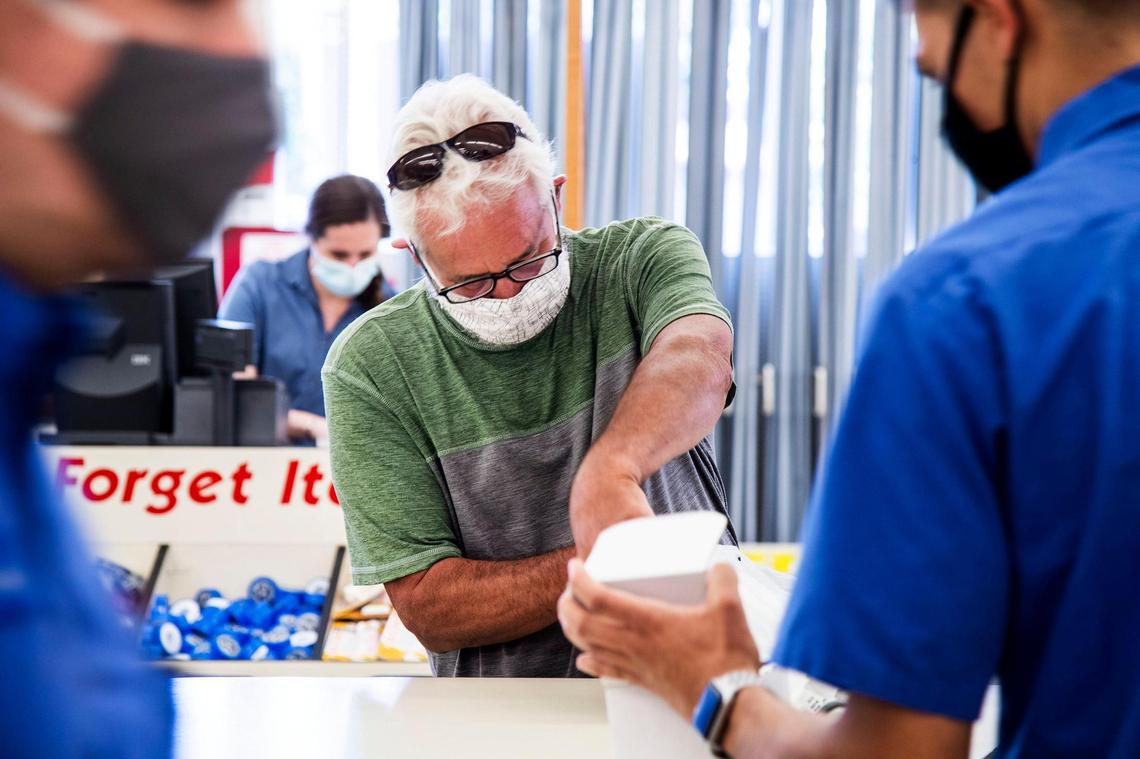 George Gunn, Boise, found help from Grover Electric and Plumbing Supply employee Eddie Torres, right, to find a replacement fan motor while visiting the Boise hardware store Saturday. Grover’s employees wear protective masks as they help customers, who are also required to wear masks while in the store during the coronavirus pandemic.