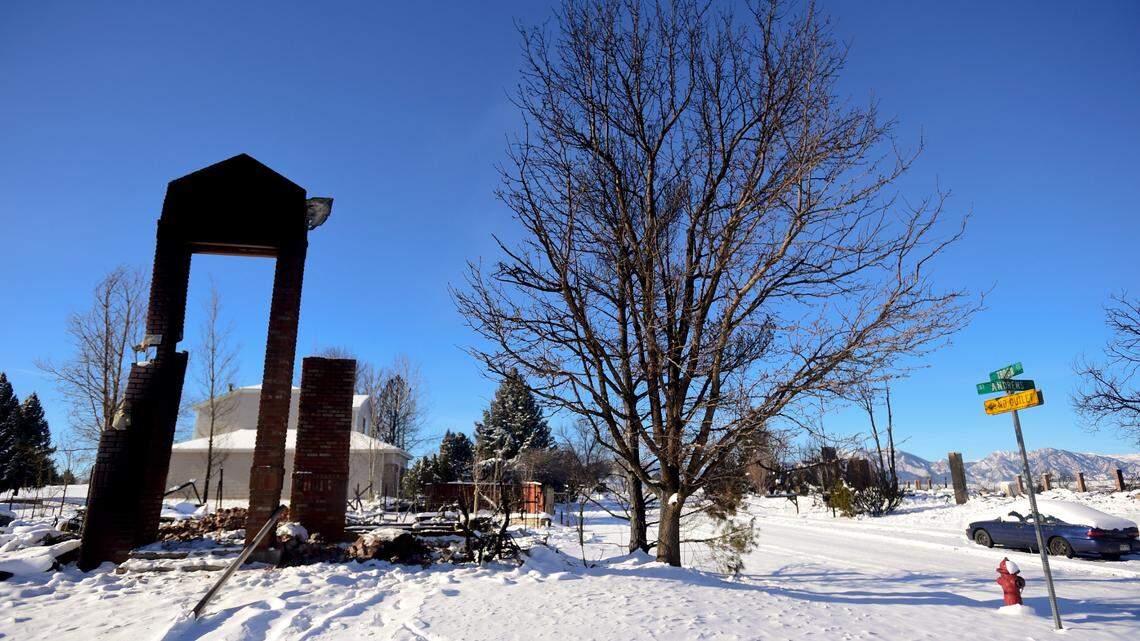 The remains of a home are surrounded by debris from the Marshall Fire in Louisville, Colorado, on Sunday, Jan. 2, 2022. An armed 24-year-old man accused of threatening firefighters in an evacuation zone lost his home in the blaze, police said.