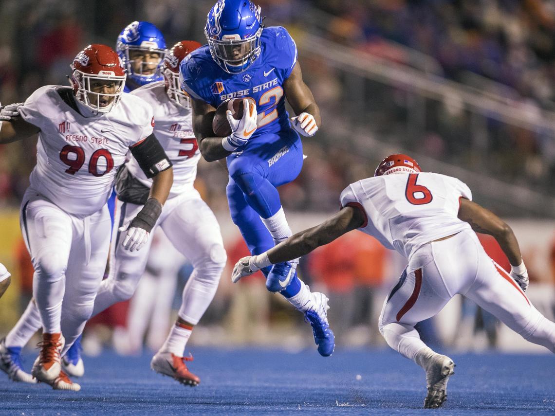 Boise State running back Alexander Mattison (22) leaps to avoid Fresno State defensive back Anthoula Kelly (6) but hits Fresno State defensive back Mike Bell (4) midair in the second quarter Friday, Nov. 9, 2018 at Albertsons Stadium in Boise.