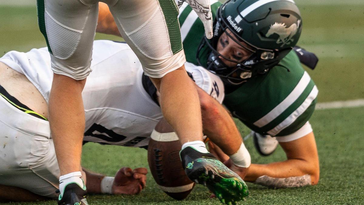 Eagle quarterback Davis Harsin, right, reaches for a fumble earlier this season. The No. 1-ranked Mustangs host No. 4 Rocky Mountain on Friday in the Herb Criner Bowl.