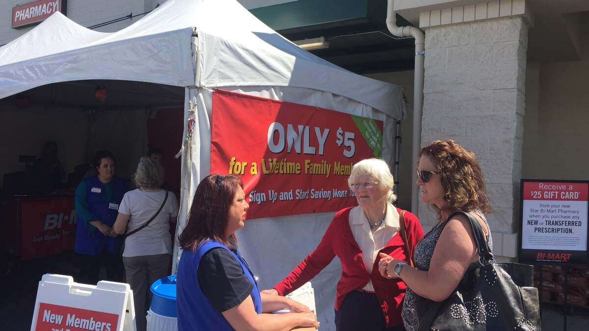 Bi-Mart employees speak with Star residents and sign them up for memberships ahead of Thursday morning's opening of the chain's newest store at 11347 W. State St. in Star.