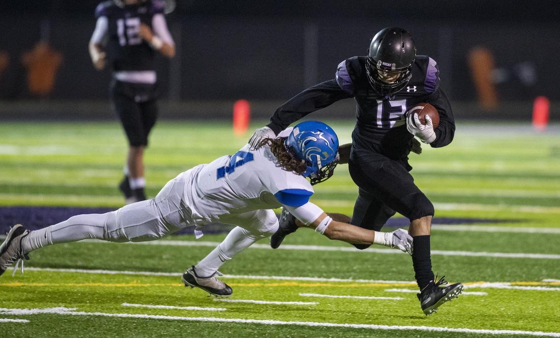Rocky Mountain’s Elijah Almanza runs for a first down before being tripped up by Timberline’s Sam Rodenbaugh in the 5A state quarterfinals Friday at Rocky Mountain High.